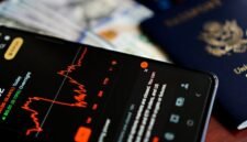 Seorang investor tersenyum sembari melihat grafik pertumbuhan dividen di aplikasi investasi, menggambarkan kegembiraan saat menerima aliran dana tunai dari keuntungan perusahaan. Pemandangan ini merefleksikan optimisme pasar modal terhadap musim panen dividen yang sedang berlangsung.